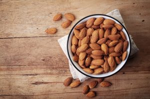 Bow Filled With Low-Carb Almonds on Wooden Table | Vitacost.com/blog