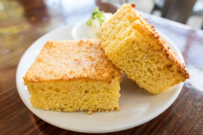 Vegan Cornbread Two Slices of Vegan Cornbread on White Dish | Vitacost.com/blog