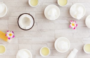bowls of coconut oil with coconut on wooden table
