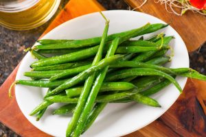 Green beans with citrus juices on white plate | Vitacost.com/blog