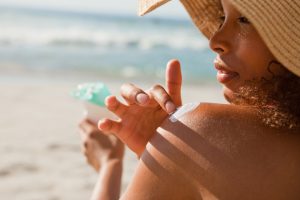 Woman Applying Natural Sunscreen at the Beach | Vitacost.com/Blog