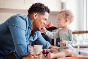 Father and son eating probiotic yogurt