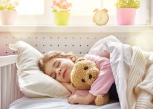 Girl Starting New School Year Going to Bed Early on a Weekday with Her Teddy Bear | Vitacost.com/blog
