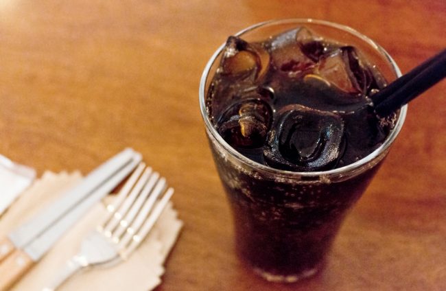 Glass of Sugary Soda with Straw on Wooden Table | Vitacost.com/blog