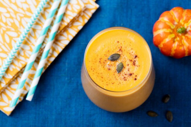 Pumpkin Pie Smoothie on Royal Blue Tablecloth with Pumpkin Prop and Teal Straws | Vitacost.com/blog