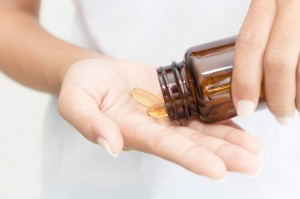 B Vitamins Pouring from Bottle into Woman's Hand