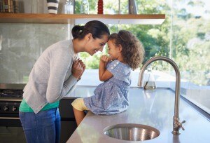 Happy Mother Connecting With Child in Kitchen