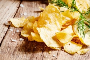 Baked Fennel Vegetable Chips with Sprigs of Dill & Sea Salt on Wood Table
