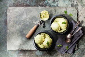 Green ice cream in bowl with mint leaves