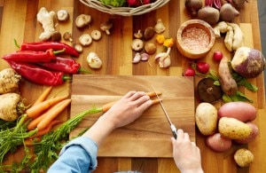 Woman on Vegan Diet Chopping Vegetables on Cutting Board
