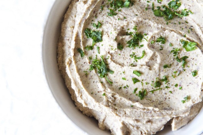Black bean and chickpea hummus in a bowl against a white background
