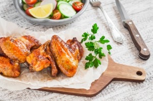 Baked chicken wings on wooden board www.vitacost.com/blog