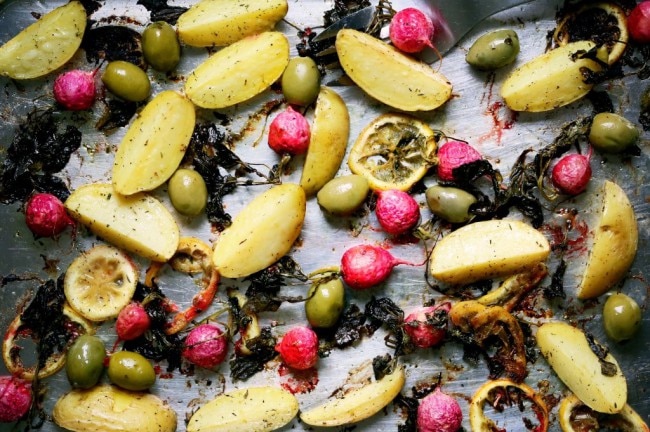 Roasted potatoes, radishes and lemon on a baking sheet www.vitacost.com/blog