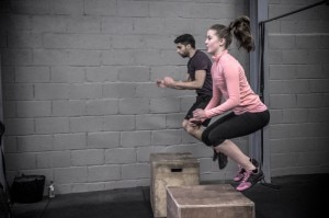 Woman in pink & man in black doing box jumps #crossfit #paleodiet | www.vitacost.com/blog