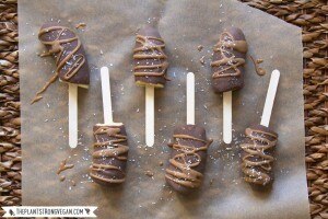 Frozen, chocolate-covered banana pops on parchment paper #icepops www.vitacost.com/blog