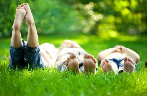 Kids Lying in Grass Enjoying Summer Fun Activities www.vitacost.com/blog