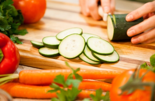 Slicing Cucumbers and Carrots on a Cutting Board for a Vegan Diet www.vitacost.com/blog