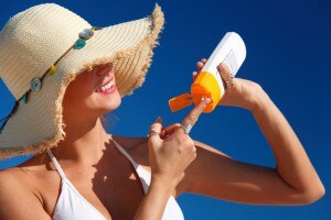 Woman applying sunscreen #healthysummer www.vitacost.com/blog