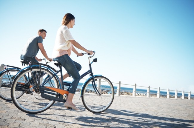 Couple Rejecting Sedentary Lifestyle Biking by the Beach www.vitacost.com/blog