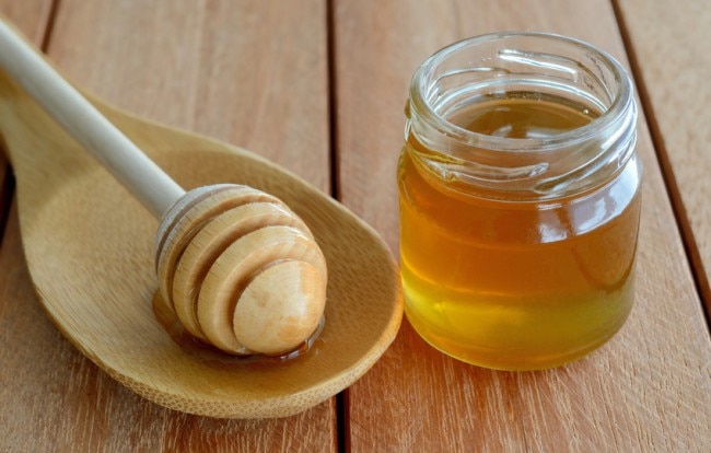 Jar of Raw Honey on Wooden Table www.vitacost.com/blog