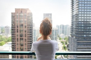 Woman on Balcony in City Worried About Pollution and Health | www.vitacost.com/blog