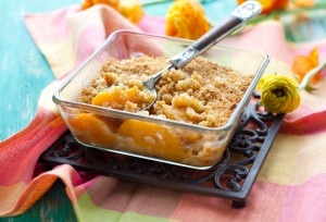 Gluten-free peach cobbler in a glass baking dish www.vitacost.com/blog