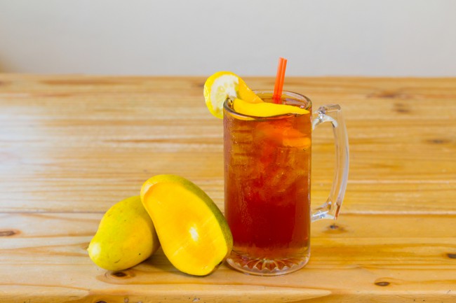 Mango Iced Tea Iced tea with mango on wooden table #healthysummer www.vitacost.com/blog