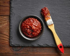 Sundried tomato marinade in bowl & on brush on slate board #recipe | www.vitacost.com/blog