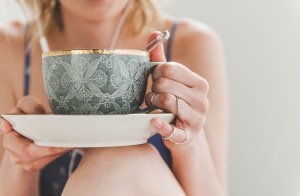 Woman Balancing Mug of Herbal Tea on Her Knee | www.vitacost.com/blog