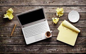 Laptop and Work Notes Scattered on Table by Senior Waiting to Retire | www.vitacost.com/blog