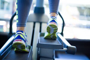 Woman training on elliptical using proper form | www.vitacost.com/blog
