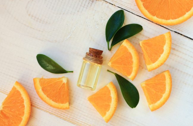 Bottle of Essential Oil With Orange Slices on White Wooden Background | Vitacost.com/blog