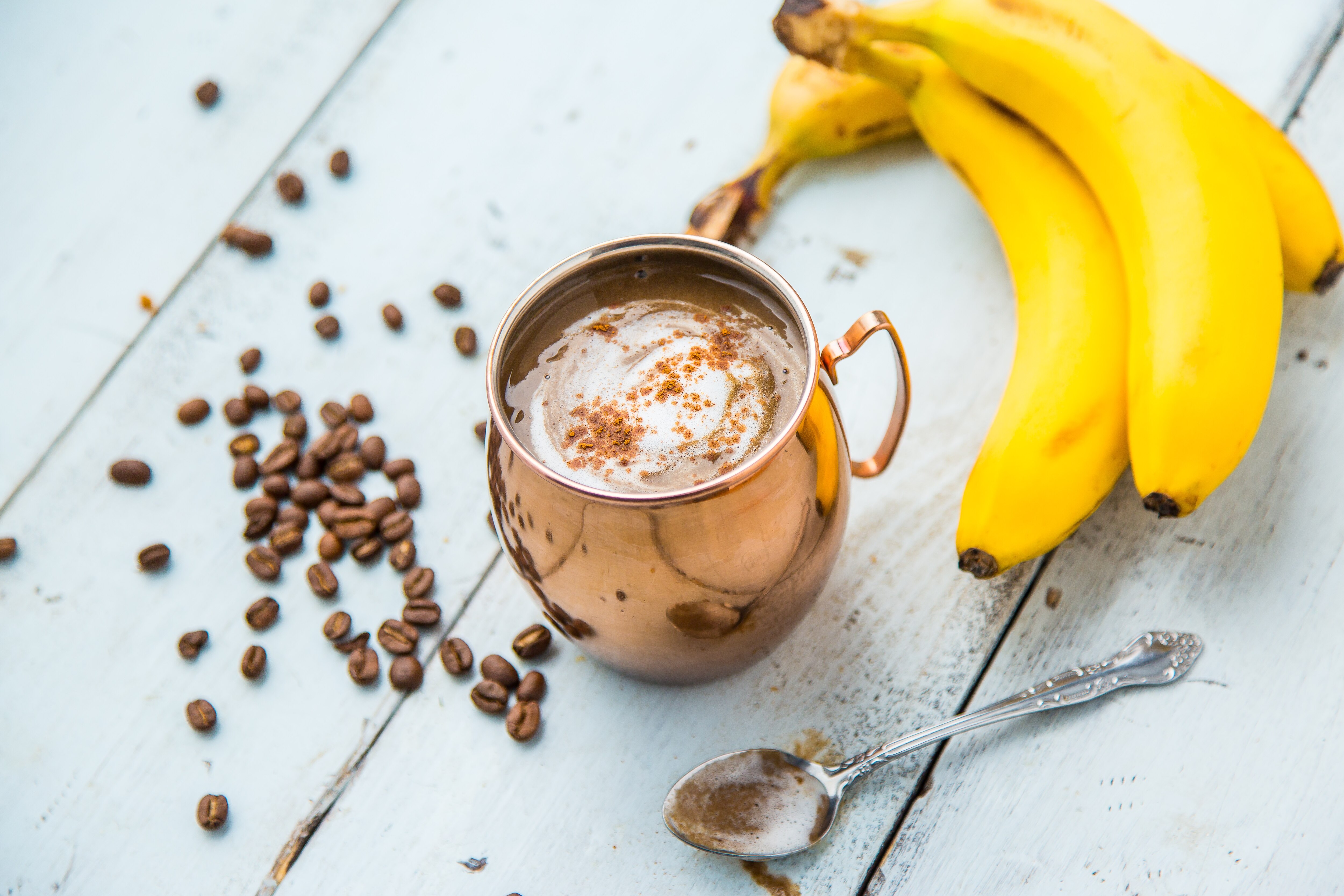 Banana Latte Smoothie with Coffee Banana latte smoothie in copper mug on wood | www.vitacost.com/blog