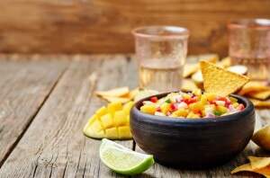 Easy mango salsa in a bowl with tortilla chip #healthysnack | www.vitacost.com/blog