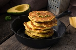 Gluten-Free Poppy Seed and Onion Pancakes Stacked on a Cast Iron Skillet with Herbs | www.vitacost.com/blog