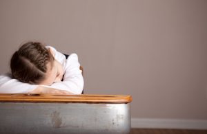Child Suffering Sleep Deprivation With Head on Desk at School | Vitacost.com/blog