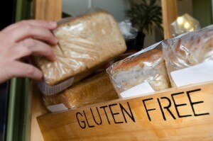 Hand Grabbing Gluten-Free Bread From the Grocery Store | www.vitacost.com/blog