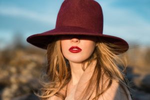 Woman wearing homemade dark lip stain and burgundy hat | Vitacost.com/Blog