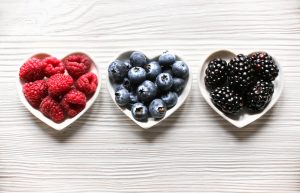 Foods High in Antioxidants Including Blueberries, Raspberries and Blackberries in Heart-Shaped Bowls | Vitacost.com/blog