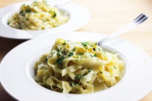 Vegan fettuccine Alfredo with cashew cream sauce garnished with parsley in a bowl | Vitacost.com/Blog