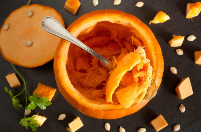 Spooning Pulp From a Cut-Open Pumpkin to Enjoy Its Health Benefits | Vitacost.com/blog
