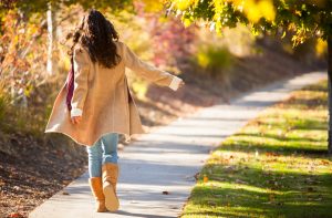 Woman Practicing Healthy Habits Walking Along Woody Path in Autumn | Vitacost.com/blog