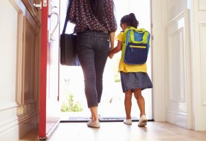 Mother and Child with Food Allergies Holding Hands as They Leave Home for School | Vitacost.com/blog