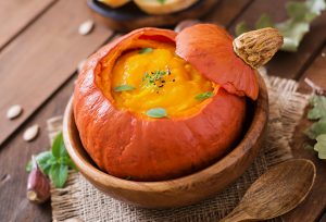 Roasted pumpkin stuffed with pumpkin puree garnished with pumpkin seeds and herbs | Vitacost.com/Blog
