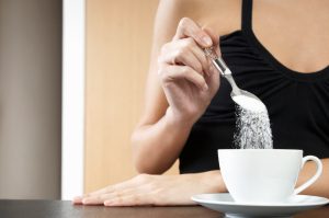 Women Spooning Excess Sugar into Coffee Putting Herself at Risk for Health Problems | Vitacost.com/blog
