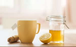 Yellow Mug of Tea Beside Jar of Raw Honey with :Lemon & Ginger | Vitacost.com/blog