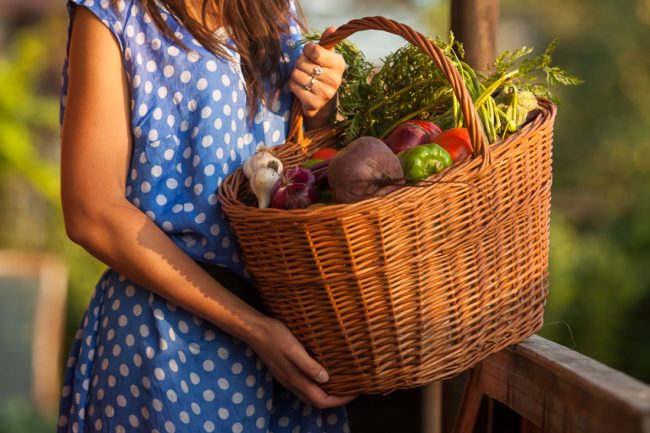 Your Fall Produce Guide: Making it Last  Woman holding basket of fall produce at the farmer's market | Vitacost.com/Blog