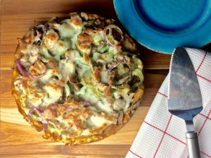 Baked Polenta Pizza Recipe with Blue Plate on Wood | Vitacost.com/blog