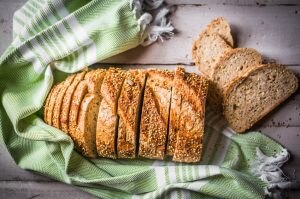 Gluten-free bread with quinoa on wood and green towel #recipe | Vitacost.com/blog