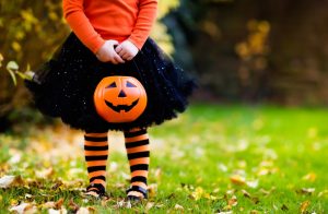 Girl Holding Pumpkin Bucket Celebrating Halloween Despite Food Allergies | Vitacost.com/blog